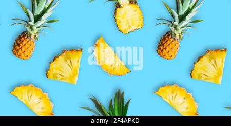 Seamless pattern of ripe whole pineapples and slices isolated on blue background Stock Photo