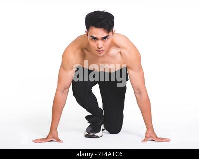 athletic man ready for start running, isolated over  white background Stock Photo