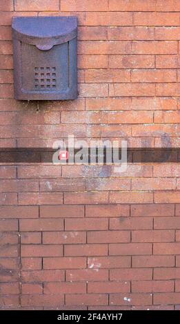 old rusted mail post box on brick wall Stock Photo