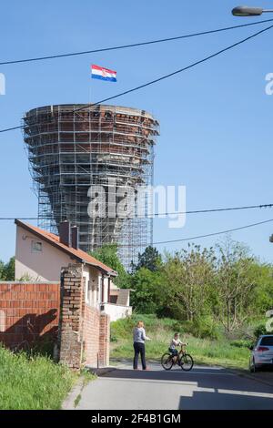 VUKOVAR, CROATIA - APRIL 20, 2018: Mother and her young child playing in Water tower, with bullet and missile holes from the 1991-1995 conflict, oppos Stock Photo