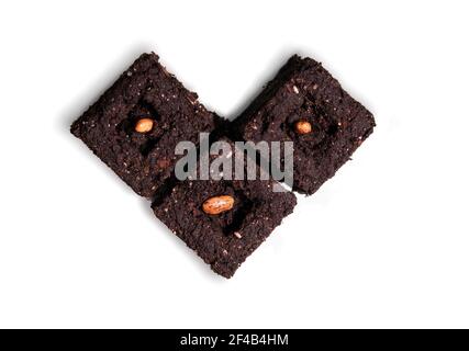 Top view of beans in soil blocks, shaped like a heart. Compressed soil blocks are  used for starting planting season early indoors and to transplant l Stock Photo