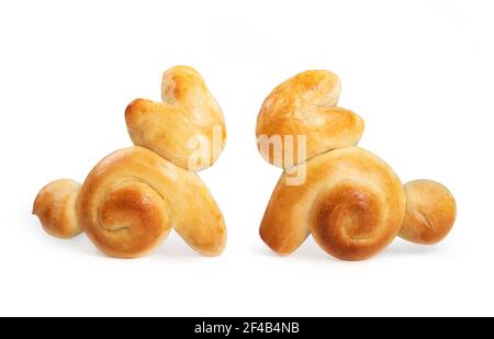 Two Easter bread bunnies. Adorable rabbit shaped yeast bread buns. Home made edible decoration for Easter holiday family table. Swiss butter bread rec Stock Photo