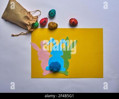 easter bunnies with tail and eggs on yellow background Stock Photo
