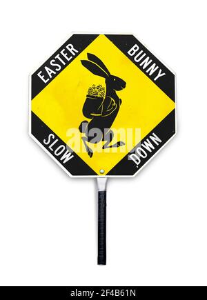 Slow down sign, Easter bunny crossing. Easter themed traffic alert signal used by crossing guards and in work zones. Yellow and black metal sign. Stock Photo