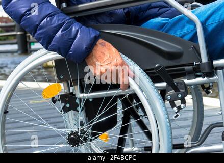 Elderly man using a wheelchair. Alone in a retirement home. Image taken during the covid pandemic. Stock Photo
