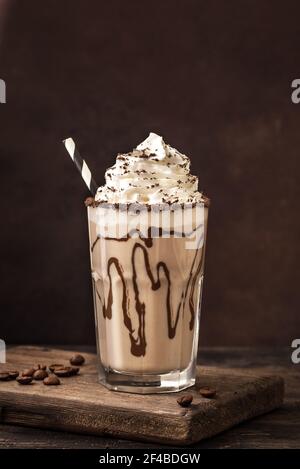 Cold Frappe Coffee or Frappuccino with whipped cream. Mudslide delicious iced coffee drink, copy space. Stock Photo
