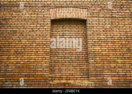 A closeup shot of a brownish-red brick wall as a background Stock Photo
