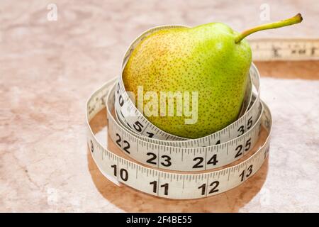 Green Pear With Measurement Tape Stock Photo