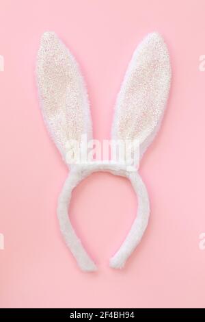Fluffy bunny ears isolated on pink background. Symbol Happy Easter Flat lay Copy space. Stock Photo