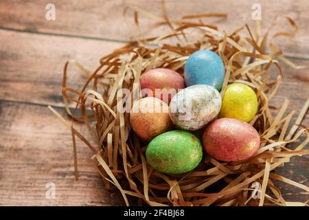 Colorful easter eggs on wooden background. . Happy Easter background. Stock Photo