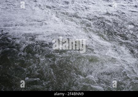 Impressive flow of water on the River Tarn, at the weir of Albi, in France, where the strong current produces white foam and powerful turbulences Stock Photo