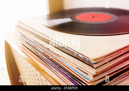 Pile of the vinyl records on the vintage radio player Stock Photo
