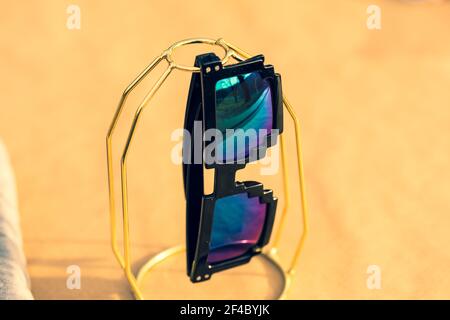 Pixel sunglasses model with blue lenses and black frame closeup in a sunny day. Selective focus Stock Photo