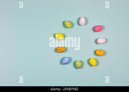 Decorated small multi-colored eggs in the shape of a circle - a place for text. Easter. Stock Photo