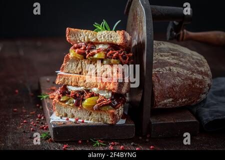 Tasty sandwich with pulled pork and pickles with Coleslaw salad. American street food. Stock Photo