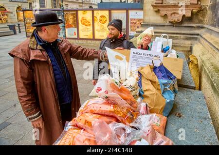 (210320) -- VIENNA, March 20, 2021 (Xinhua) -- Coachman Hermann Hofer (L) accepts donations for Fiakers horses at the Stephansplatz square in Vienna, Austria, March 19, 2021. Viennese Fiaker coachmen have set up a feed box in the city center, where animal lovers can donate fruit and vegetables for the horses. As one of the most famous tourism projects of Vienna, Fiaker horse carriages encountered operational difficulties during the COVID-19 pandemic. (Photo by Georges Schneider/Xinhua) Stock Photo