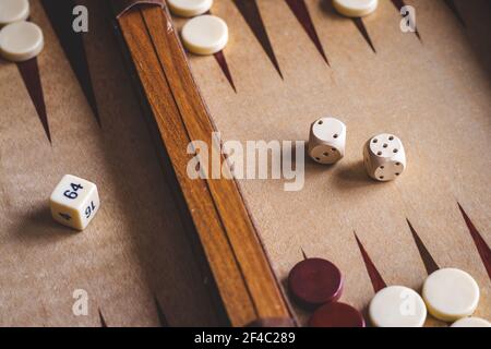 Backgammon board game. Playing leisure game. Dice on board. Stock Photo