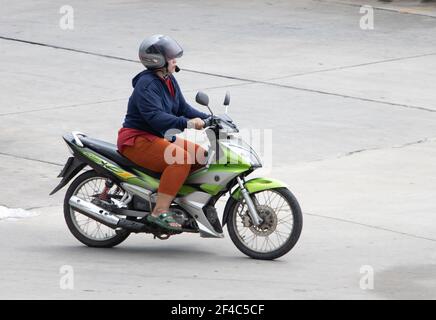 SAMUT PRAKAN, THAILAND, JUNE 26 2020, woman with helmet rides a motorcycle Stock Photo