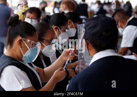 Non Exclusive: NEZAHUALCOYOTL, MEXICO - MARCH 19: Medical personnel prepare Sinovac Covid-19 vaccine injections for adults over 60 years of age at the Stock Photo