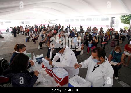 Non Exclusive: NEZAHUALCOYOTL, MEXICO - MARCH 19: Medical personnel prepare Sinovac Covid-19 vaccine injections for adults over 60 years of age at the Stock Photo