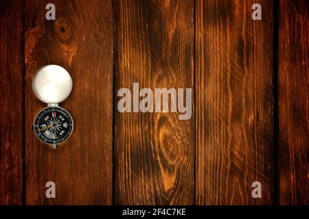 compass on the brown wooden table background. Stock Photo