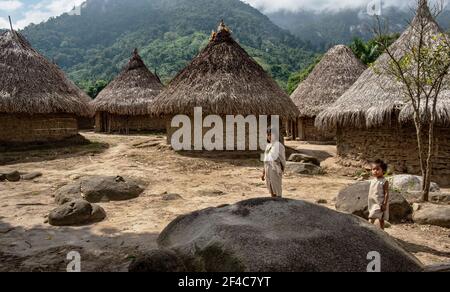 A Kogi woman and child walk through their village in La Guajira, Colombia. Stock Photo