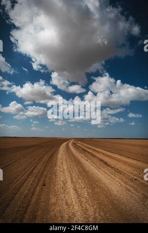 Clouds float above a makeshift road in the desert of northern La Guajira, Colombia. Stock Photo
