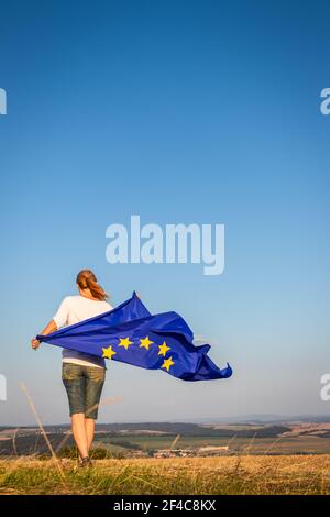 European Union flag against blue sky waving Stock Photo - Alamy