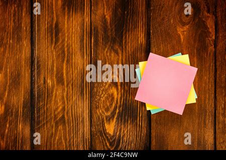 Blank colorful stickers on wooden brown table. Stock Photo