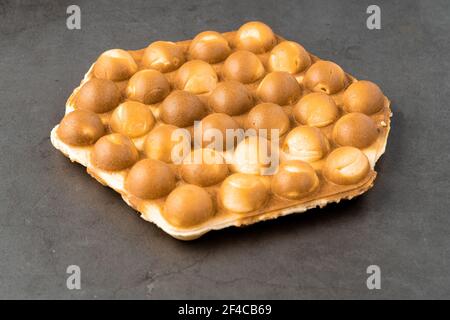 bubble waffle without topping on stone background Stock Photo