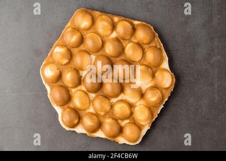 bubble waffle without topping on stone background Stock Photo