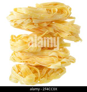 Fettuccine pasta nests close up on a isolated white background. Stock Photo