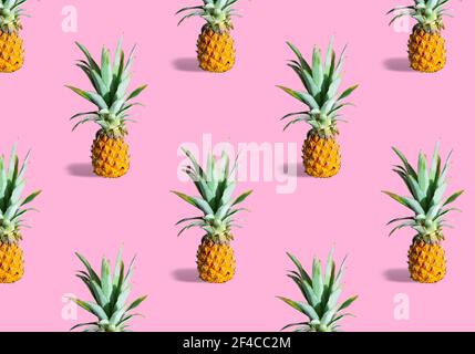 Seamless pattern of fresh ripe pineapples isolated on pink background Stock Photo