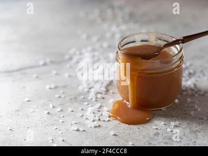 Homemade salted caramel in a glass jar. Selective focus Stock Photo