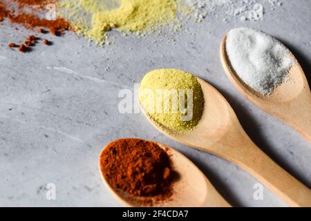 Spices in wooden spoon on a gray background Stock Photo