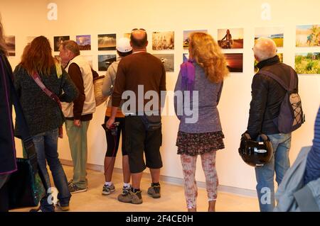 Attenders to the awards ceremony of Beni Trutmann photo contest at the photo exhibition (Ajuntament Vell, Sant Francesc Xavier, Formentera, Spain) Stock Photo