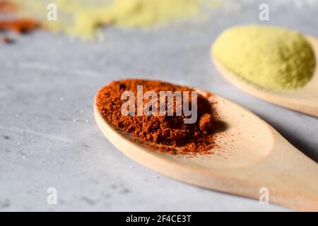 Spices in wooden spoon on a gray background Stock Photo