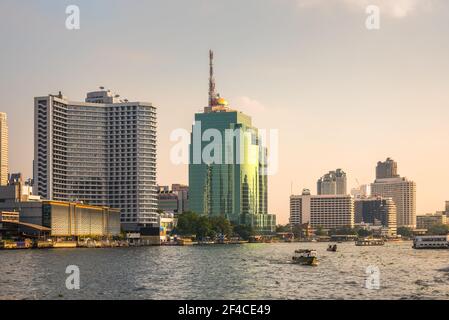 Bangkok Skyline as Seen from the Eastern Chao Phraya River Embankment at Sunset Stock Photo