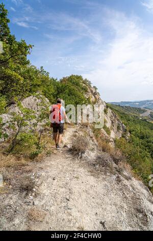 One woman hiking in the Parco regionale della vena del gesso romagnola. Brisighella, Borgo Rivola, Borgo Tossignano. Emilia Romagna, Italy, Europe. Stock Photo