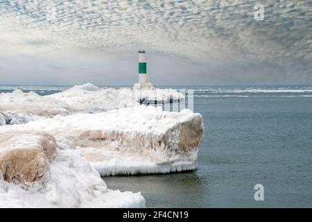 Nautical channel market with green stripe on icy Lake Michigan pier in winter Stock Photo