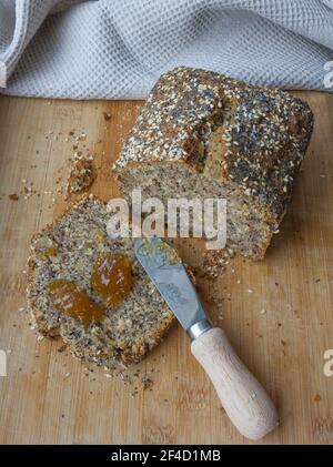 Whole grain banana bread, multigrain organic homemade bread on wooden background Stock Photo