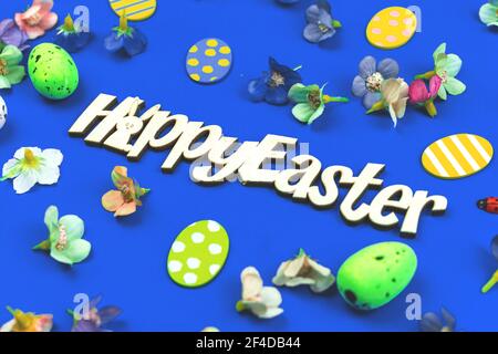 Happy Easter flat lay composition with spring easter decoration on blue background Stock Photo