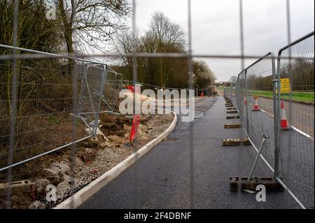 Little Amersham, Buckinghamshire, UK. 18th March, 2021. HS2 have cut an access point road through trees off the A413 as they build a haul road and prepare to construct the Little Amersham ventilation shaft. This will be one of 4 ventilation shafts into the the tunnel that they will be boring underneath the Chilterns which is an Area of Outstanding Natural Beauty. The High Speed 2 Rail link from London to Birmingham puts 108 ancient woodlands, 33 SSSIs and 693 wildlife sites at risk. Credit: Maureen McLean/Alamy Stock Photo