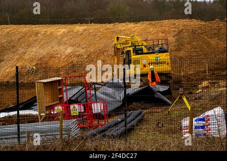 Little Amersham, Buckinghamshire, UK. 18th March, 2021. HS2 have destroyed another swathe of beautiful countryside as they build a haul road and prepare to construct the Little Amersham ventilation shaft. This will be one of 4 ventilation shafts into the the tunnel they will be boring underneath the Chilterns which is an Area of Outstanding Natural Beauty. HS2 have rerouted a public footpath around their huge construction site off the A413. The High Speed 2 Rail link from London to Birmingham puts 108 ancient woodlands, 33 SSSIs and 693 wildlife sites at risk. Credit: Maureen McLean/Alamy Stock Photo