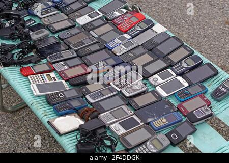 Big collection of old mobile phones at flea market Stock Photo