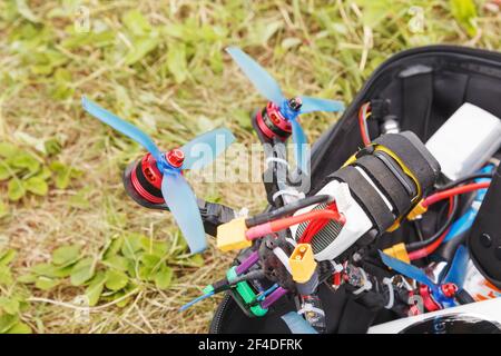 A fpv high-speed racing drone copter lying on the grass Stock Photo