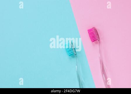 Pink and blue toothbrushes for him and her, minimal design with copy space Stock Photo