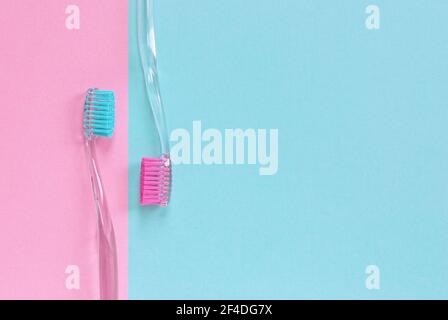 A couple of toothbrushes on the blue and pink backdrop with copy space Stock Photo