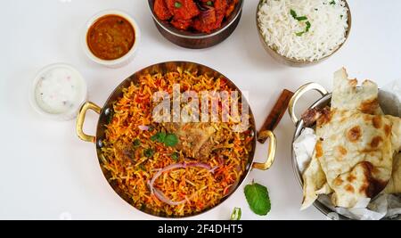 Indian Non veg meal Chicken biryani Roti Chilli chicken rice salan and Raita isolated on white Stock Photo