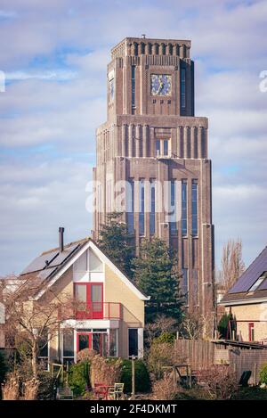 Striking block-shaped tower along the river 'Hollandsche IJssel', not far from the city of Gouda, Holland. Stock Photo